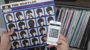 Looking at a Discogs App on a smart phone, with Beatles album in other hand
